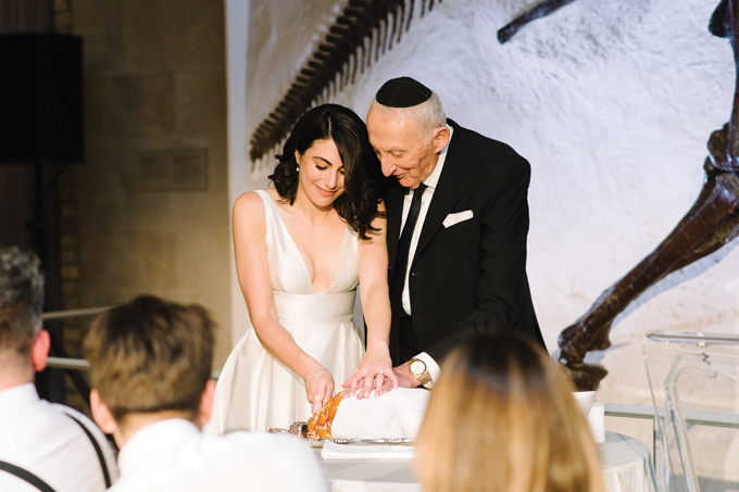 A photograph of hamotzi, or blessing of bread, at a Jewish wedding