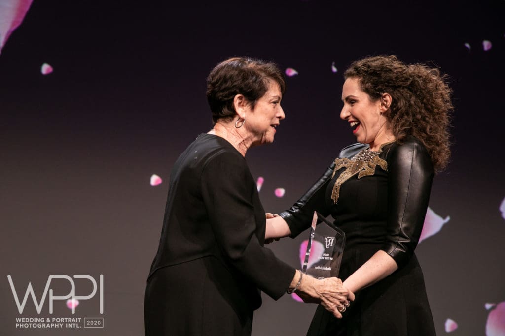 WPPI's Arlene Evans and Lindsay Adler on stage at WPPI 2020 awards ceremony.