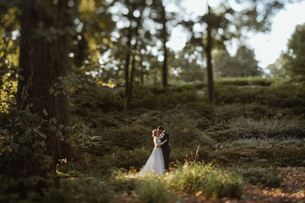 bride and groom posing together at outdoor wedding in new york botanical garden by amy sims photography sunny