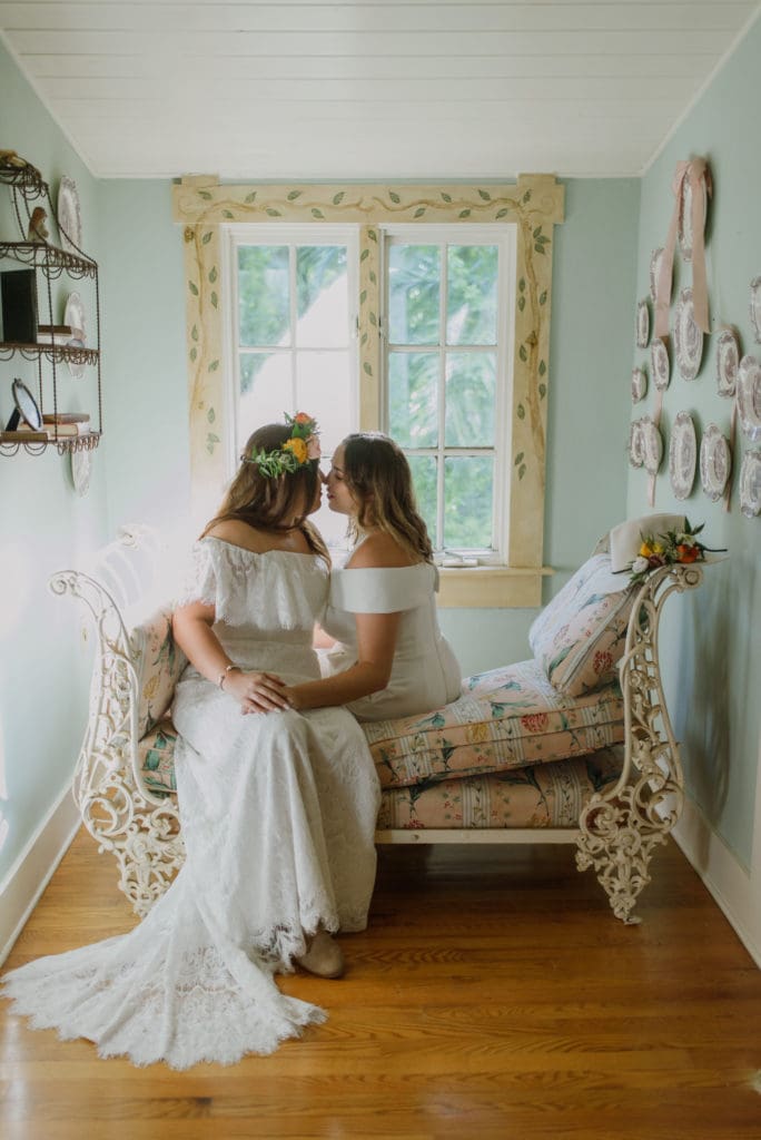 Micro-Wedding moment between brides, same-sex bridal couple.