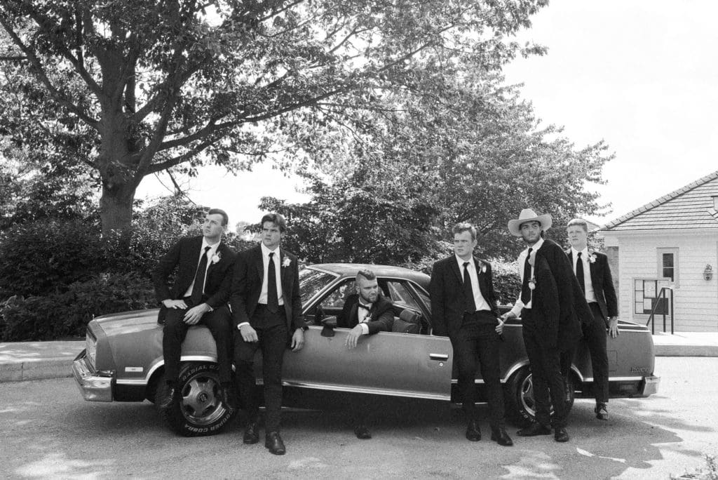 Groomsmen pose for portraits with 1983 El Camino