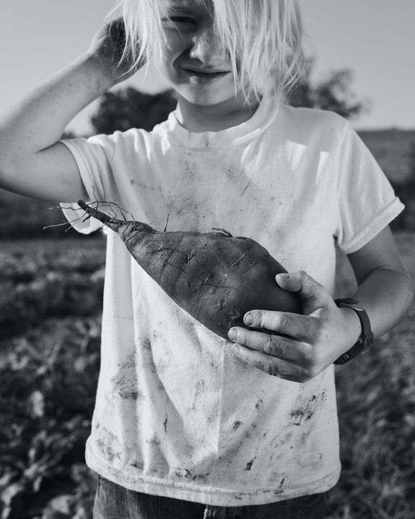 A boy with a sweet potato.