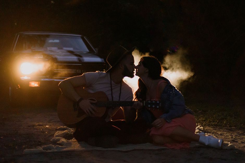an eye-catching portrait from an engagement session with a car.