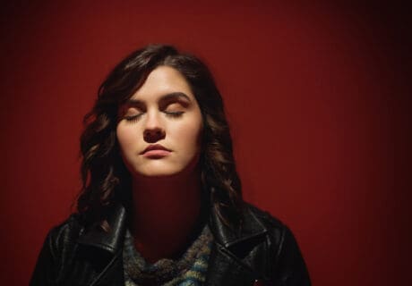 senior portrait with red background