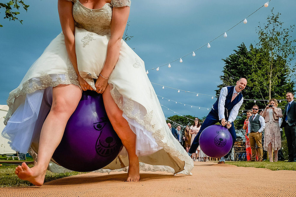 unadulterated joy captured of wedding couple on space hoppers.