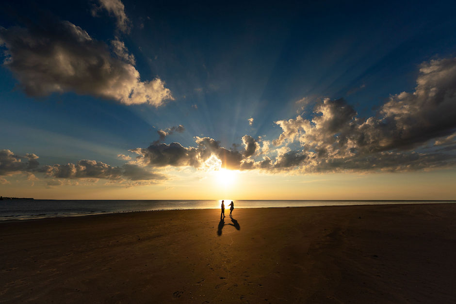 eye-catching portrait of engagement shoot against sunrise.