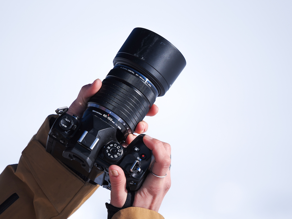 Image of the OM-1 In the hands of a user.