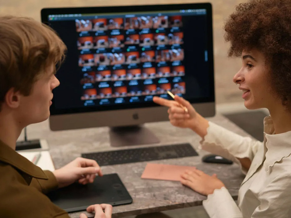 Capture One Live lets you edit as you go. Man and woman here edit on a desktop.