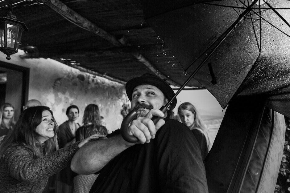 man with umbrella standing with group of people.