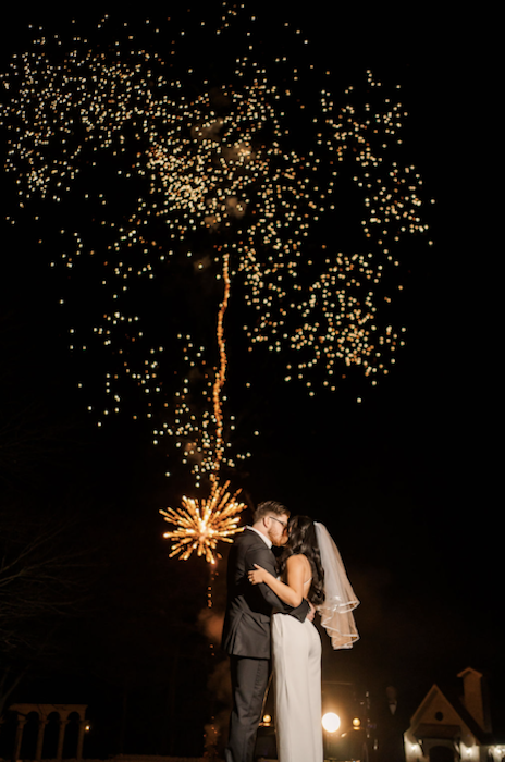 national photography month kicks off with image of bride and groom under fireworks.