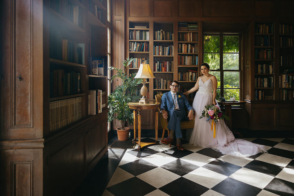 Bride and groom portrait in library room.