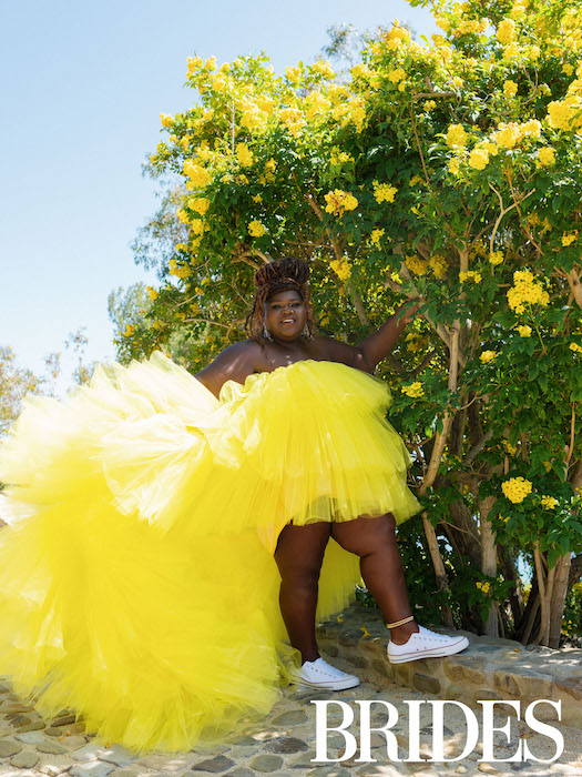 Gabourey Sidibe in yellow under yellow flowers, for BRIDES magazine.