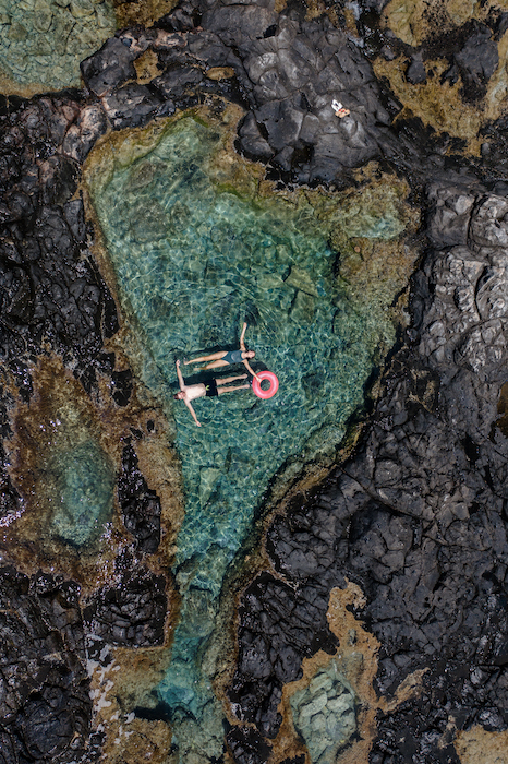 documentary style photo of two bathers, taken with a drone.