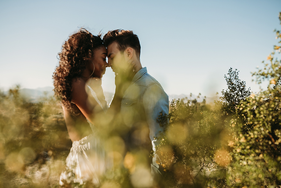 woman and man couple outside in harsh light.