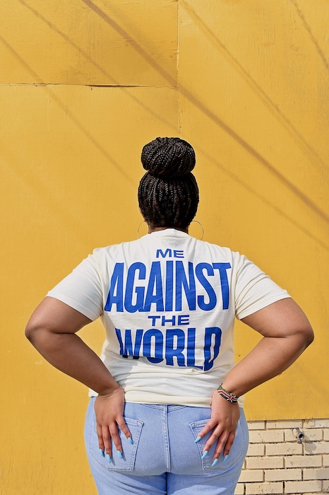 Polly Irungu against yellow wall