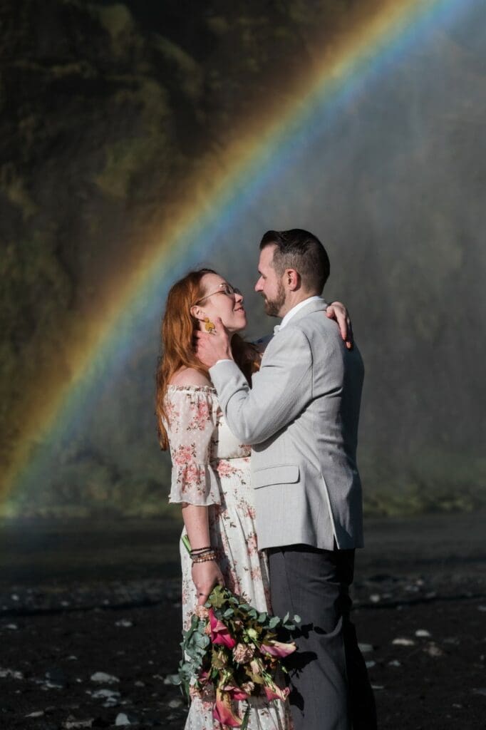 Couple at waterfall with rainbow