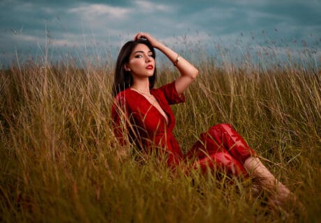 After image of woman in red dress in field