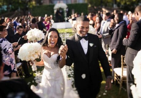 wedding recessional of bride and groom holding hands